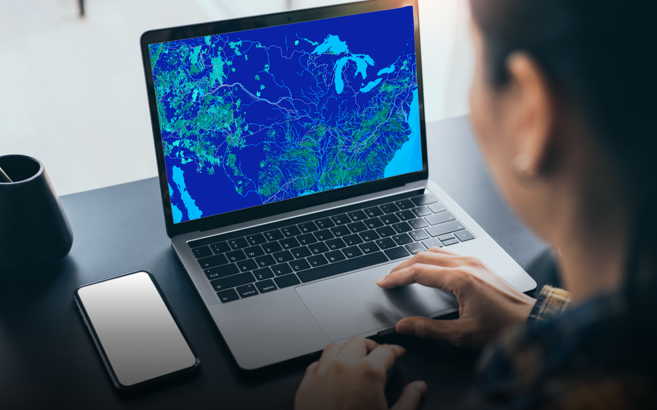 A GIS expert giving advice to business people using sticky notes and a gridded map 
