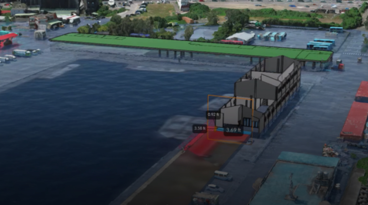 3D scene of active building construction site showing a building, vehicles, and blue water