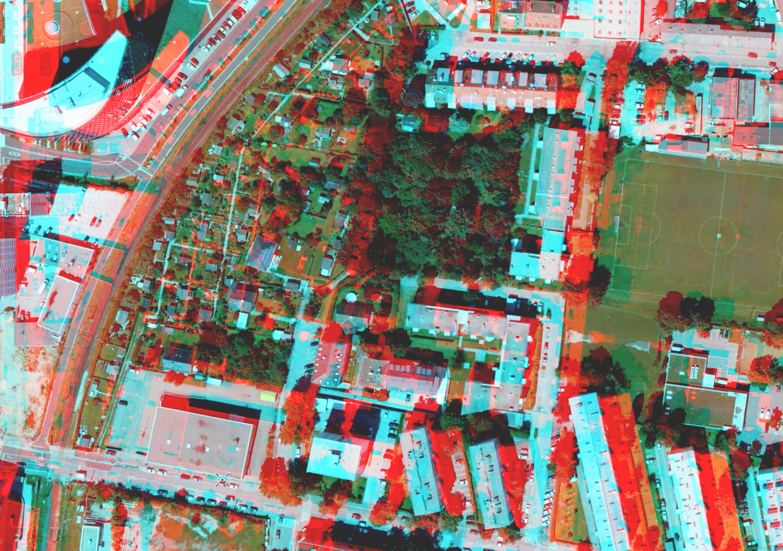 Een stereokaart van een dichtbevolkt woongebied toont een rode overlay waarop kenmerken in 3D kunnen worden weergegeven