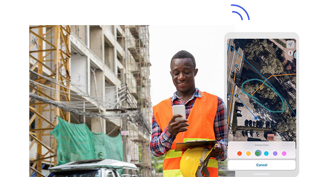 Fieldworker holding a mobile phone, hard hat, and a clipboard at a construction site. Phone screenshot with the area circled in green.,Fieldworker holding a mobile phone, hard hat, and a clipboard at a construction site. Phone screenshot with the area circled in green.