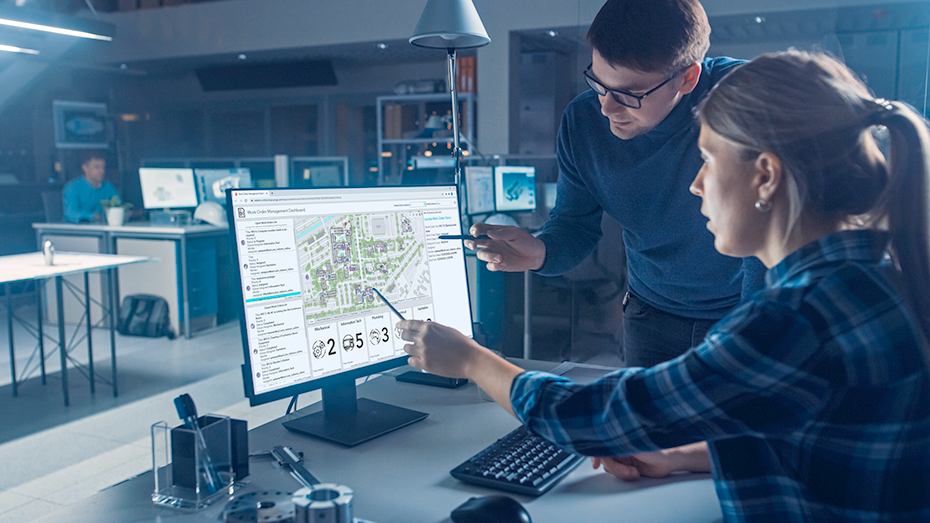 Man and woman looking at desktop screen of an indoor mapping dashboard to monitor building status,Man and woman looking at desktop screen of an indoor mapping dashboard to monitor building status