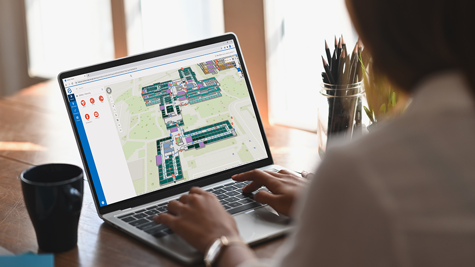 Person working from home on a laptop using ArcGIS Indoors to review space usage on an indoor map,Person working from home on a laptop using ArcGIS Indoors to review space usage on an indoor map
