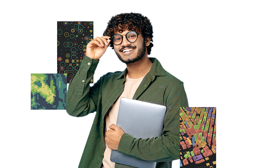 A young man wearing glasses and a green shirt holding a silver laptop