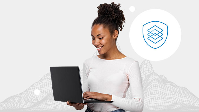 A young woman with a white top typing on a black laptop with an inset icon of stacked sqaures