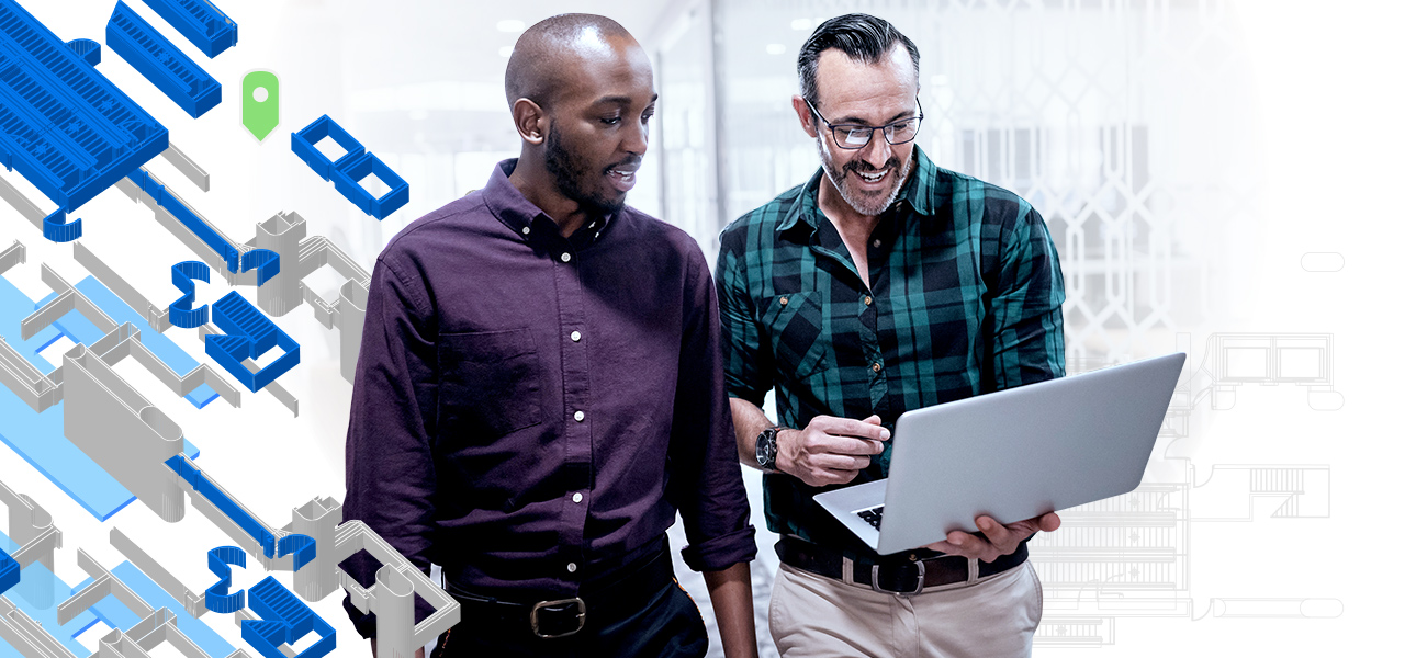 Two facilities managers looking at a laptop with an indoor GIS interface next to digital rendering of building areas