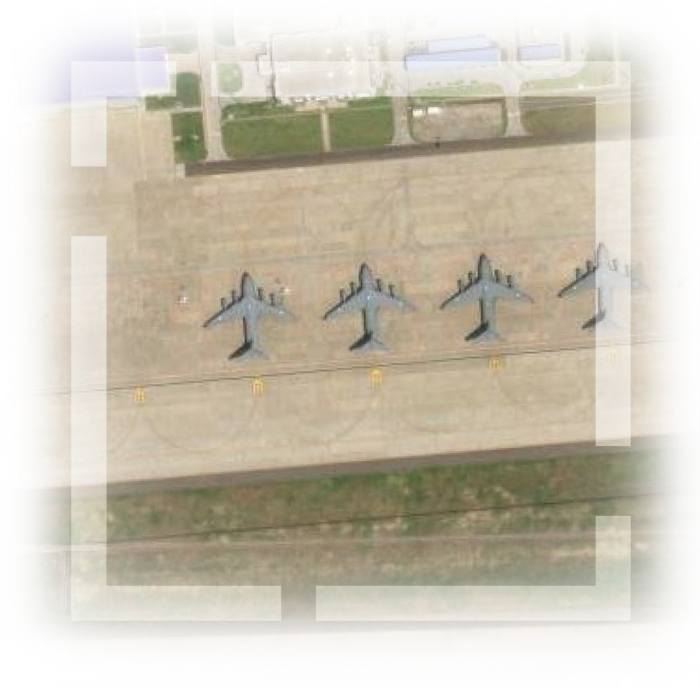 Image of a military airfield with jets parked on the tarmac.
