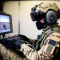A person wearing military gear and camouflage uniform working on a simulation training featuring a 3D video 