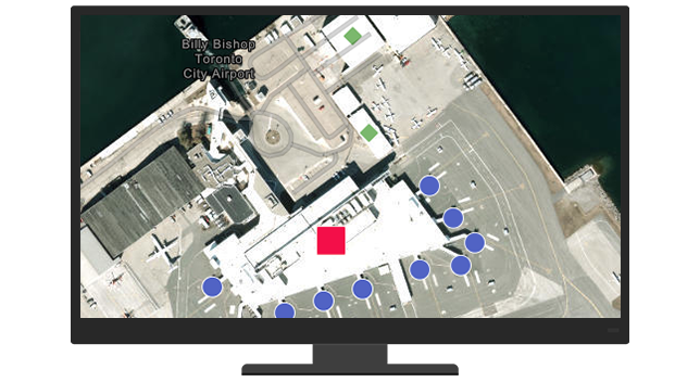 A desktop computer monitor displaying a satellite image of an airport terminal with shapes marking different features