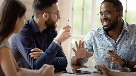 Group of people talking at a conference table 
