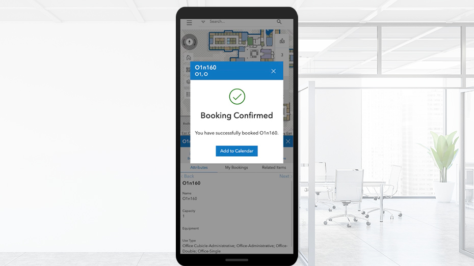 A mobile phone screen with a popup window saying booking confirmed in ArcGIS Indoors Spaces