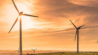 Four windmills and a blue sky with white clouds