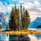 Tall mountain peaks with green pine trees and a blue body of water