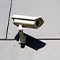 A white surveillance camera attached to a wall
