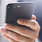  Two hands holding a smartphone and a credit card