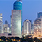 A city skyline with many modern buildings lit at night
