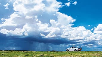 Image of a cloudy sky over a green field