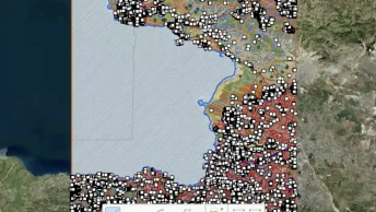 A computer screen displaying a colorfully shaded map alongside several menus and tabs with various analysis options