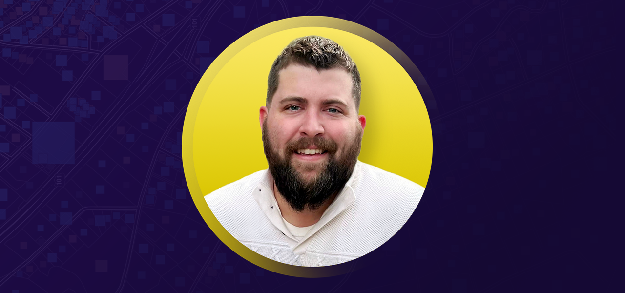 Chris Berryman smiling in a white sweater overlaid on a yellow and purple graphic background