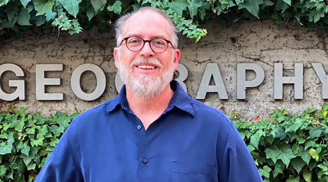 Kurt Towler with glasses and a gray-white, short beard and a blue collared shirt