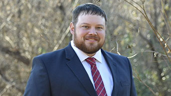 A portrait of Alex Harper taken outdoors