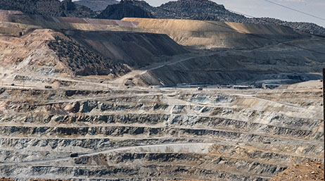 Quarry landscape from a faraway with trucks and mining operations in the distance
