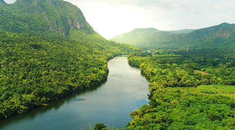 A large river surrounded by forests and mountains