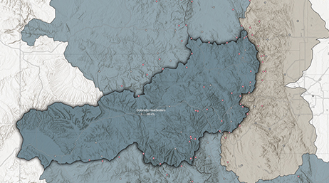 A topographic map with various mountain ranges highlighted in different shades of blue and grey and small red dots dispersed throughout