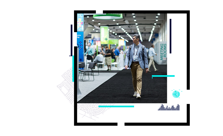 A photo of a person in a blazer and a backpack walking through a large, brightly-lit conference exhibit hall
