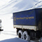 World Food Programme (WFP) snow trucks drive through a snow covered mountain range