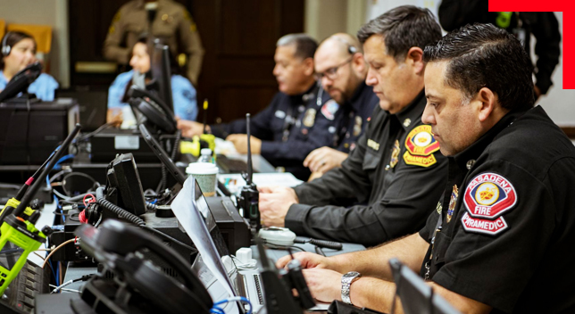 A group of Pasadena Fire Paramedics sitting in a command room at dispatch desk