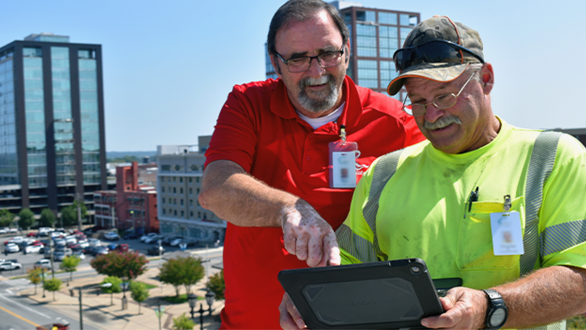 Utility staff looking at a tablet computer outside
