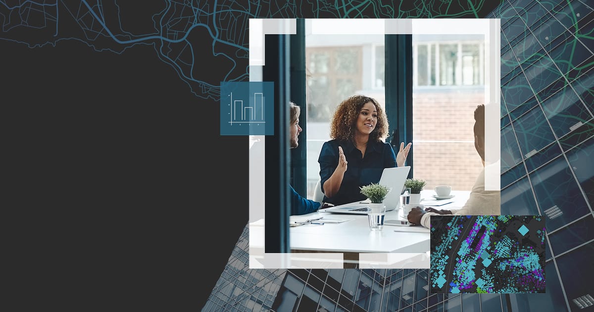 A GIS expert giving advice to business people using sticky notes and a gridded map 