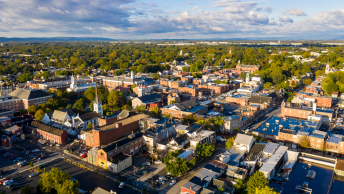 An aerial view of Bethlehem, Pennsylvania, featuring red brick buildings and dense green trees