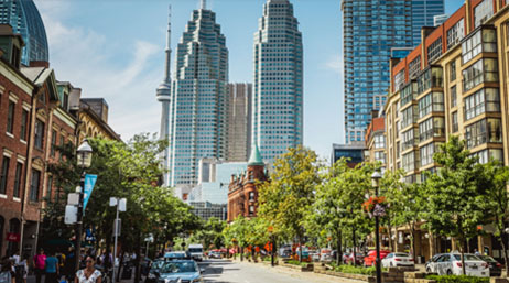 A view of a city with tall buildings in the background and the street in the foreground