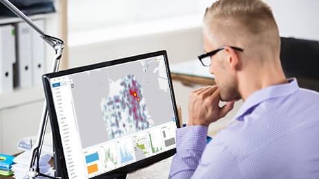 A man reviewing data patterns on his desktop computer.