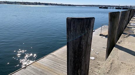 Sparkling blue river and a wood dock