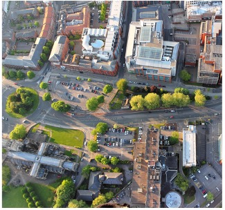 aerial view of city showing streets, modern buildings, and town