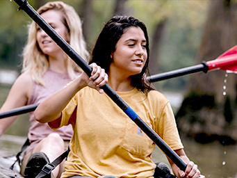 A close up of two people kayaking