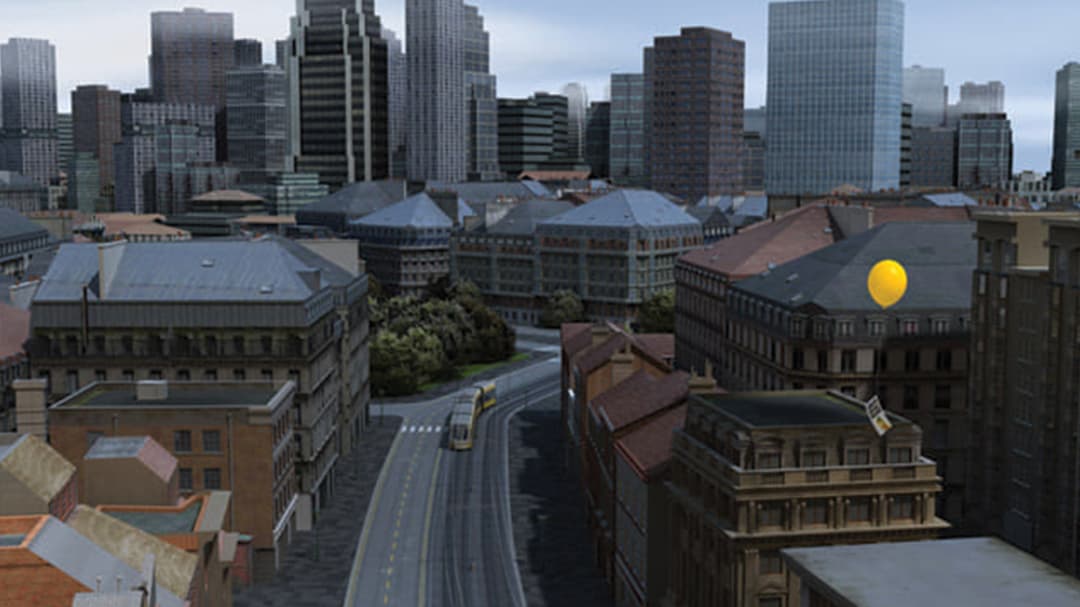 Aerial view of street looking toward downtown buildings with yellow balloon floating by